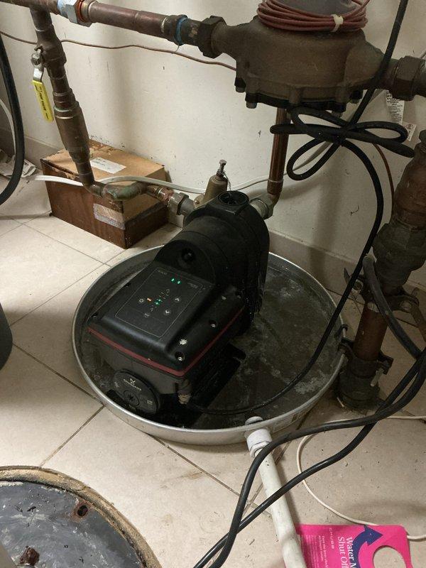Responded to service call for loud noise coming from booster pump system in utility room. Upon arrival, inspected the complete water pressure booster system including the pressure tank, circulator pump, control unit, and associated copper piping. Identified excessive noise originating from the pump motor and vibration throughout the system. Evaluated the pump mounting, electrical connections, and pressure settings on the digital control panel. Checked pressure vessel for proper air charge and inspected all valves and connections for secure operation. Documented existing system configuration with copper supply lines, brass fittings, and flexible blue tubing connections. Assessed the overall condition of the 17-year-old installation including signs of mineral deposits and age-related wear on components. Provided recommendations for addressing the noise issue and ensuring continued reliable operation of the booster pump system.