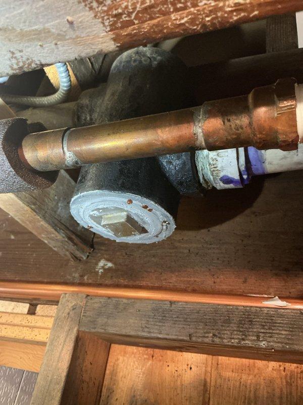 Responded to service call for residential property with water service currently shut off. Conducted thorough assessment of existing plumbing infrastructure, which consisted of aging galvanized piping requiring replacement. Inspected copper pipe assembly installed through wooden structural framing in crawlspace area, noting varying degrees of patina and oxidation indicating different installation periods. Examined existing water supply system including white PVC piping, insulated copper lines, flow meter installation, and associated valves and fittings. Documented condition of pipe insulation, metal flanges, and connection points throughout the accessible plumbing system. Photographed all relevant components to support comprehensive estimate for complete piping replacement project. Provided detailed assessment and recommendations for upgrading from deteriorated galvanized system to modern piping materials.