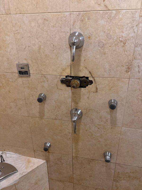 Responded to a low water pressure complaint in an interior shower system. Upon inspection, identified a failing shower mixer cartridge as the source of reduced flow. Replaced the defective cartridge to restore proper water pressure and functionality to the multi-head shower system.
