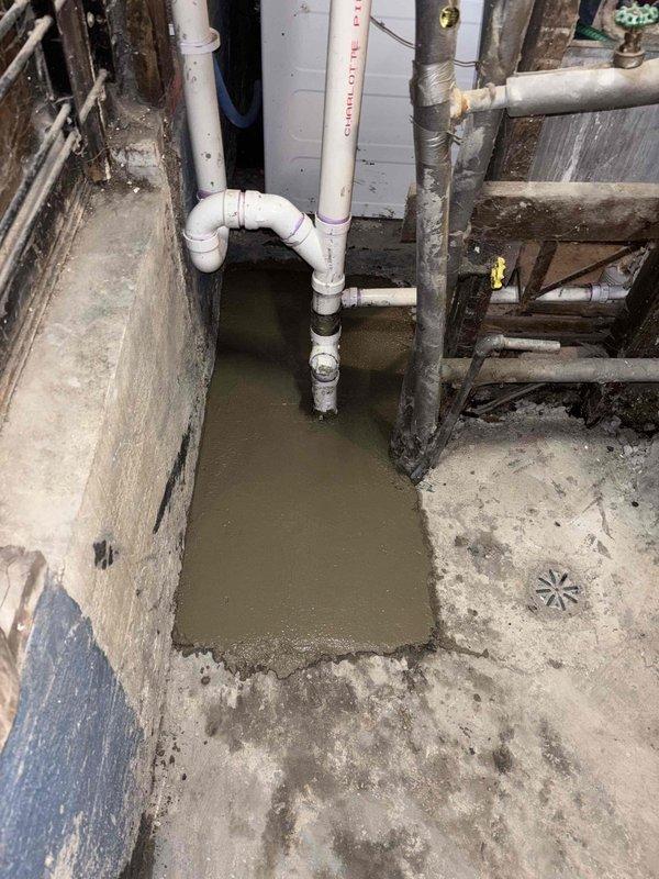 Conducted residential drain and sewer estimate in basement area with significant standing water accumulation in floor depression. Documented existing Charlotte Pipe PVC drainage system configuration and identified moisture infiltration issues affecting concrete surfaces and wooden structural elements. Coordination required for follow-up visit to excavate and address drainage concerns, with additional consultation scheduled to review remediation options and system modifications with property owner.