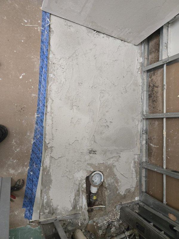 Conducted on-site plumbing estimate for piping installation in active construction area. Assessed exposed wall sections and documented existing conditions, including vertical pipe run with blue insulation tubing requiring proper integration. Evaluated pressure gauge installation on existing pipe fixture and provided recommendations for completing piping system in renovation space.