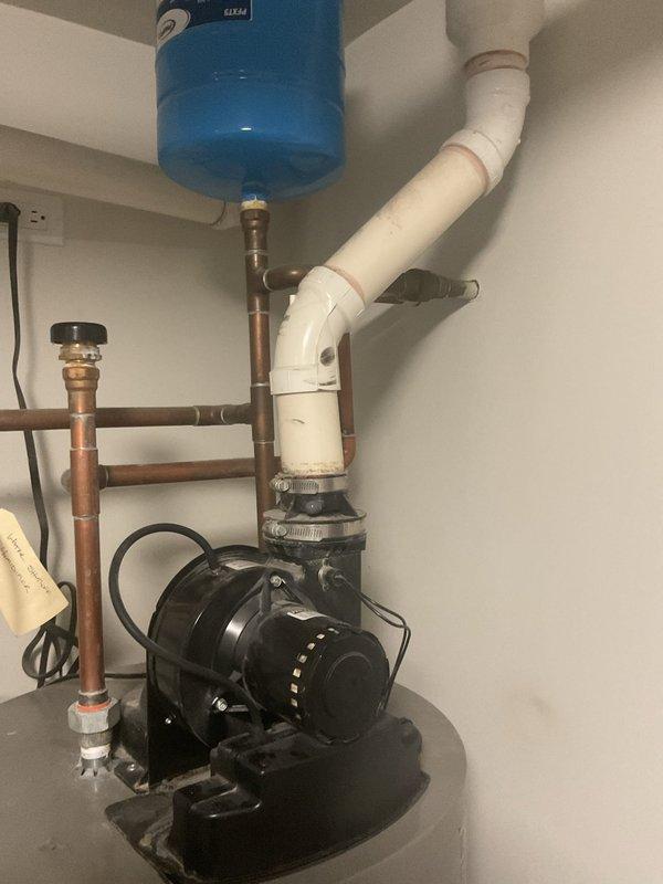 Conducted assessment of dual water heater system serving residential hot water and radiant heating applications. Primary Bradford White Defender unit exhibited short cycling, error code display, and flashing indicators. Both water heaters approximately 11 years old and approaching end of service life. Documented existing mechanical room configuration including circulation pumps, expansion tanks, pressure relief systems, copper supply and return piping, and integrated booster pump assembly. Customer requesting replacement of both units with electric water heaters and exploring tankless options for improved efficiency and space optimization.