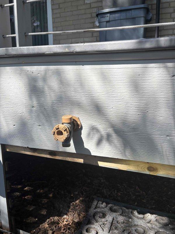 Installed new PRIER outdoor spigot valve assembly with quarter-turn shut-off mechanism on wooden deck surface. Completed installation of brass valve body with copper pipe connection and threaded outlet, ensuring proper placement and secure mounting for exterior water access.