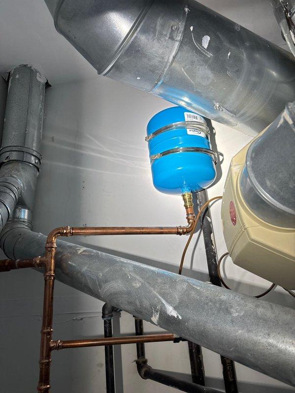 Reinstalled residential water heater in utility room that had been previously removed. Connected all copper supply and discharge piping with proper fittings and joints. Secured unit in place and verified all plumbing connections for proper operation and leak-free performance.