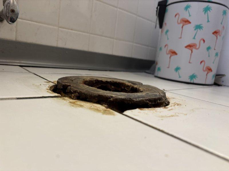 Responded to afternoon appointment request for bathroom plumbing repair. Upon inspection, identified a severely deteriorated drain gasket with significant wear, cracking, and degradation around the edges. The gasket showed brittle material failure with pieces peeling away from the main structure. Brown staining and mineral deposits were visible around the drain opening on the white tile surface, indicating prolonged water exposure and potential seal failure. Documented existing conditions with photographs for service records. Repair work was sold and scheduled for completion.