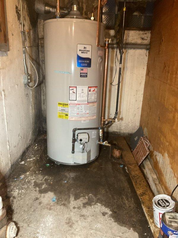Completed water heater replacement in residential basement utility room. Removed existing unit and installed new Bradford White water heater with proper copper piping connections, gas control valve assembly, and all required safety components. Ensured proper venting, configured hot and cold water supply lines, and verified all connections for leaks. System tested and operational upon completion.