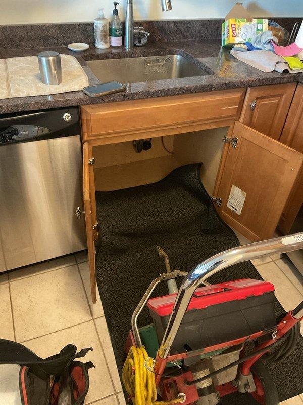 Responded to kitchen sink backup issue caused by blockage beyond the P-trap. Accessed plumbing beneath sink cabinet, cleared obstruction from drainage system, and restored proper water flow. Tested sink operation to confirm complete drainage and verified all connections were secure with no leaks.