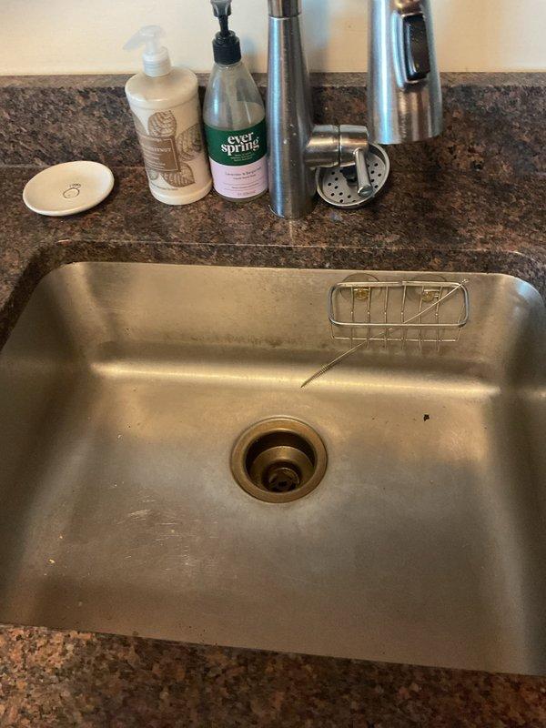 Responded to kitchen sink backup issue caused by blockage beyond the P-trap. Accessed plumbing beneath sink cabinet, cleared obstruction from drainage system, and restored proper water flow. Tested sink operation to confirm complete drainage and verified all connections were secure with no leaks.