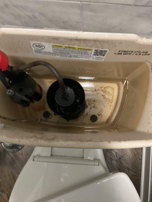 Responded to priority service call for malfunctioning toilet with broken internal components. Upon inspection, identified failed flapper valve and deteriorated fill valve assembly with significant mineral buildup and hard water deposits throughout tank interior. Replaced defective flapper valve and chain assembly, installed new fill valve with adjustable float mechanism, and adjusted water level to manufacturer specifications. Tested flush cycle multiple times to ensure proper operation and verify no leaks. Addressed customer's concerns regarding slow draining issues and recommended evaluation of main drain line for potential blockage or root intrusion, particularly given correlation with recent rainfall events.