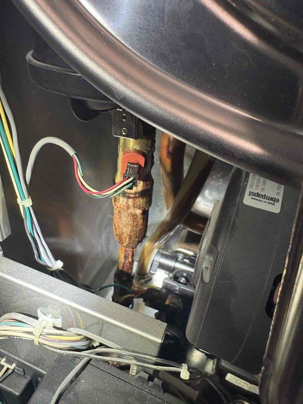 Responded to service call for 10-year-old tankless water heater experiencing intermittent on/off cycling issues. Upon inspection, discovered significant corrosion and deterioration on copper gas supply line and internal heat exchanger components. The corroded copper piping showed heavy oxidation and surface degradation that could compromise system safety and performance. Documented equipment condition including digital control panel readings, internal heat exchanger assembly, blower motor components, and manifold valve system. Identified corrosion as likely contributing factor to reported intermittent operation issues requiring further repair or component replacement to restore reliable function.
