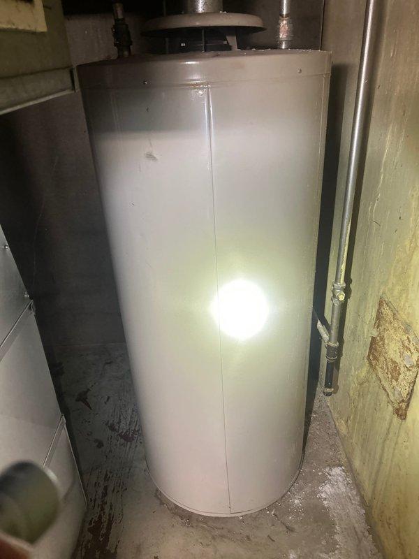 Responded to service call for tankless water heater consultation and estimate. Upon arrival, inspected existing conventional tank-style water heater in basement utility area. Unit showed signs of age with surrounding wall discoloration indicating potential previous moisture issues. Assessed current plumbing configuration, available gas line capacity, electrical requirements, and venting pathways necessary for tankless conversion. Discussed advantages of tankless systems including energy efficiency, continuous hot water supply, and space savings versus traditional tank models. Evaluated basement layout and clearance requirements for proper tankless unit installation. Documented existing conditions through photography and provided professional recommendations for appropriate tankless water heater sizing based on household hot water demands. Prepared comprehensive estimate for complete removal of existing tank water heater and installation of new tankless system including necessary gas li