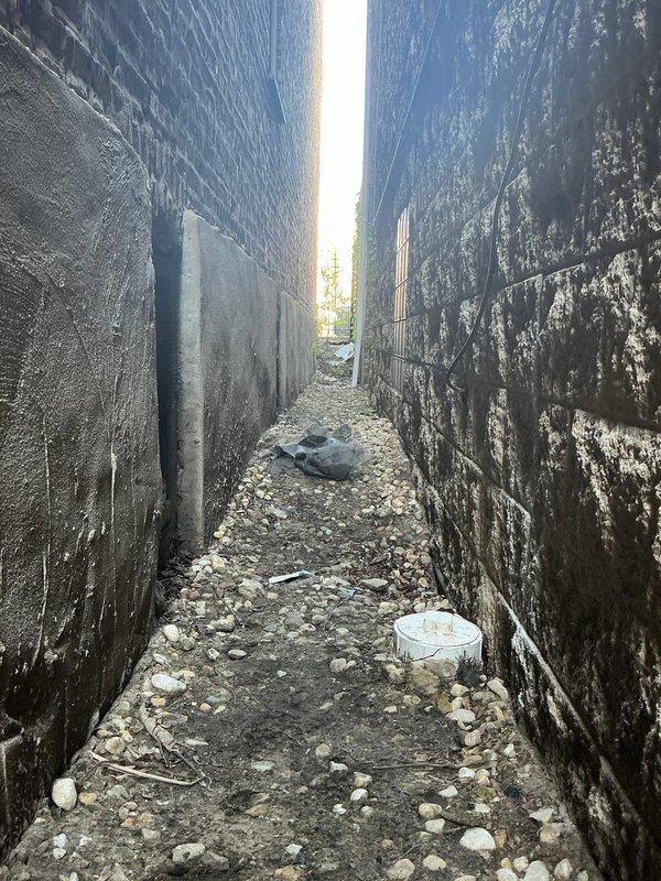 Performed video inspection of commercial sewer line to diagnose drainage issues at multi-unit residential property. Inspection accessed system through exterior cleanout located in rear alleyway between structures, documenting conditions of underground sewer lateral and identifying any blockages, root intrusion, or structural defects affecting system performance.