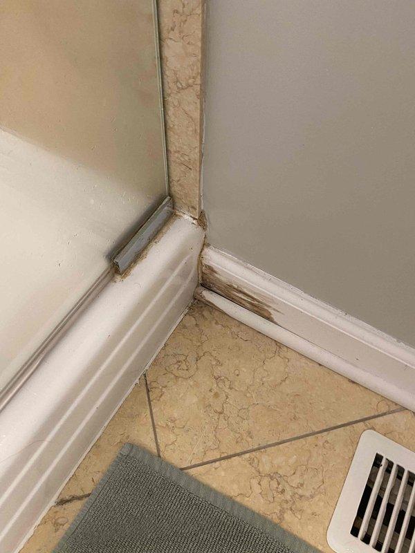 Responded to a water leak in the basement storage unit of a century-old home. Upon inspection, identified water damage and staining along baseboards and wall corners, indicating chronic moisture infiltration. Assessed plumbing systems and addressed the leaking pipe issue. Documented existing water damage with photographs showing discoloration on baseboards and floor areas. Completed necessary repairs to resolve the active leak and prevent further water intrusion.