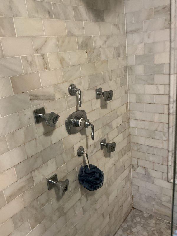 Completed VIP plumbing maintenance service for tankless water heater system and luxury shower installation. Inspected tankless water heater mechanical room setup including PVC supply and drain lines, ball valve operation, electrical control panel functionality, and proper sealing at floor penetrations. Verified multi-head shower system with thermostatic mixing valve, body spray jets, and chrome fixtures operating correctly with no leaks or pressure issues detected.
