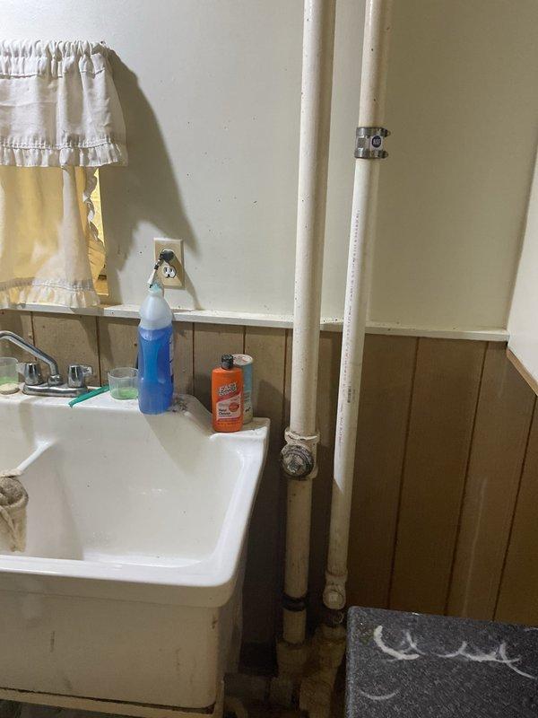 Responded to a slow-draining laundry sink in the basement utility area. Upon inspection, confirmed drainage issues affecting the utility sink with water backing up and draining at a significantly reduced rate. Assessed the plumbing system and identified concerns with the main sewer line, noting visible cracking that would require repair to prevent future drainage complications and potential backups throughout the residence.