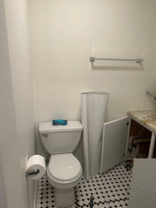 Completed plumbing estimate for bathroom piping installation. Assessed existing white PVC drainage and waste water lines beneath floor structure, including elbow joints and connections within wooden framed cavity. Evaluated bathroom plumbing configuration including toilet installation, under-vanity plumbing connections, and overall drainage system layout to provide accurate piping estimate.