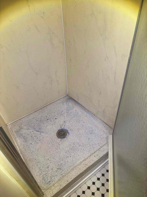 Responded to reported leak in Unit 2 and conducted initial assessment of shower stall plumbing system. Performed measurements and photographic documentation of affected areas, including ceiling junction and shower pan assembly with center drain. Inspection revealed potential water intrusion points requiring further evaluation of piping connections and waterproofing integrity.