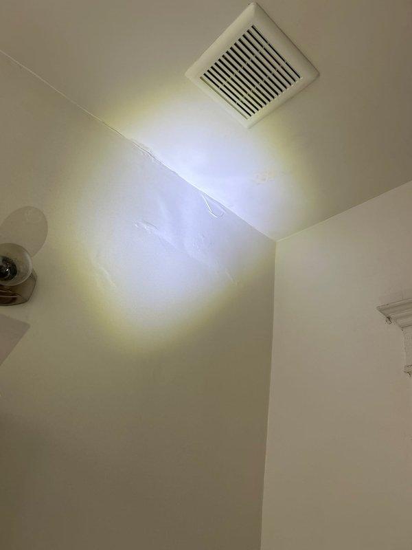 Responded to water leak affecting second floor originating from third floor bathroom area in 135-year-old residence. Conducted thorough inspection of potential source points including wall cavity between bathroom and kitchen, toilet connections, and sink plumbing. Investigated aged floor drain fixture showing significant corrosion and deterioration, examined ceiling-mounted ventilation system, and assessed surrounding tile work displaying water damage indicators. Documented conditions with photographic evidence for record. Four-hour diagnostic service completed to identify leak source in historic plumbing system.