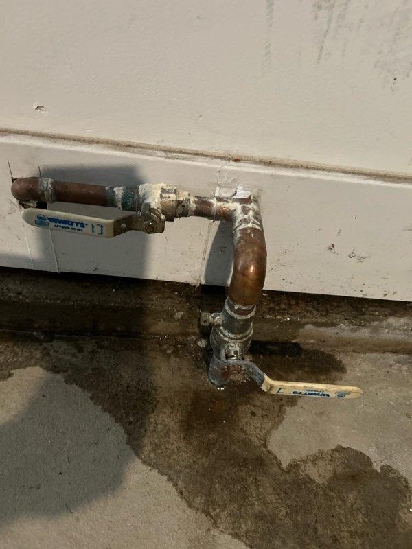 Responded to water leak service call and performed comprehensive leak detection on copper plumbing system. Located active leak at pipe joints near baseboard level, evidenced by significant water staining on concrete floor, corrosion on copper fittings, and mineral deposit buildup at connection points. Tagged affected pipes for identification, documented damage with photos showing extent of water intrusion and pipe deterioration, and completed leak repair to restore system integrity.