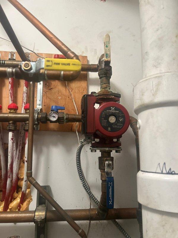 Responded to service call to diagnose issues with Grundfos circulator pump valve connected to radiant floor heating system and Kohler smart valve. Upon inspection, examined the red Grundfos circulator pump assembly mounted in mechanical room, including associated copper piping, ball valves, pressure gauges, and zone control components. Evaluated pump operation, electrical connections, and integration with radiant heating system. Assessed copper piping configuration, valve functionality, and system pressure readings. Inspected Kohler smart valve installation and performed diagnostic testing to identify operational concerns. Documented existing conditions of heating circulation system components including visible oxidation on copper fittings and overall system configuration for estimate preparation.