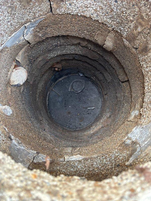 Responded to priority commercial water pressure issue caused by deteriorated galvanized piping. Accessed main water line through exterior ground-level cleanout port in paved patio area to assess flow restriction. Documented existing conditions of access point and surrounding infrastructure, noting significant mineral buildup and corrosion consistent with aged galvanized pipe systems that restrict water flow over time.