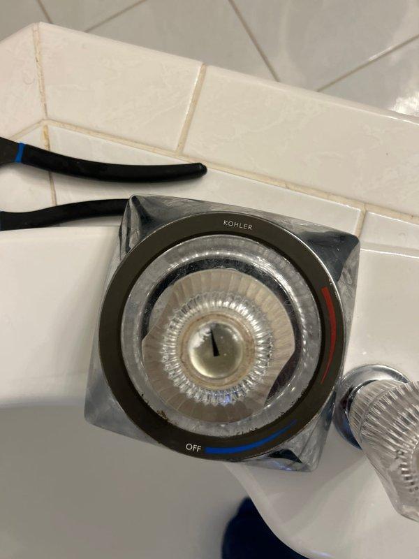 Responded to service call for two plumbing leaks: one under the kitchen sink and another at the shower handle. Inspected and assessed the Kohler thermostatic shower valve system, which showed signs of leakage at the handle assembly. Examined the kitchen sink plumbing connections and identified the source of the under-sink leak. Documented both areas with photos showing the shower control fixture with its circular valve mechanism and the exposed plumbing access point. Provided recommendations for repair work to address both leak locations.