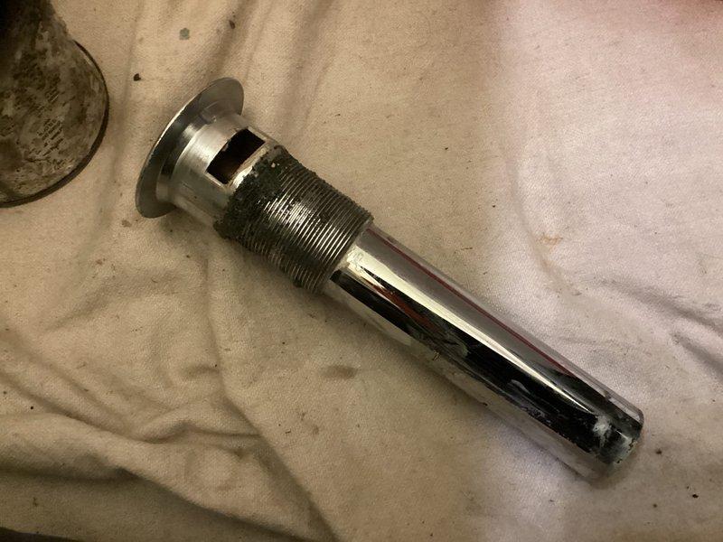 Responded to service call for stuck bathroom sink stopper. Successfully removed the malfunctioning pop-up drain assembly, which showed signs of mineral buildup and water spotting that had caused the stopper mechanism to seize. Disassembled the drain tailpiece and cleaned all components. Documented existing conditions with photographs showing the chrome drain fixture in the sink basin and the removed tailpiece assembly. Customer presented with repair estimate for consideration.