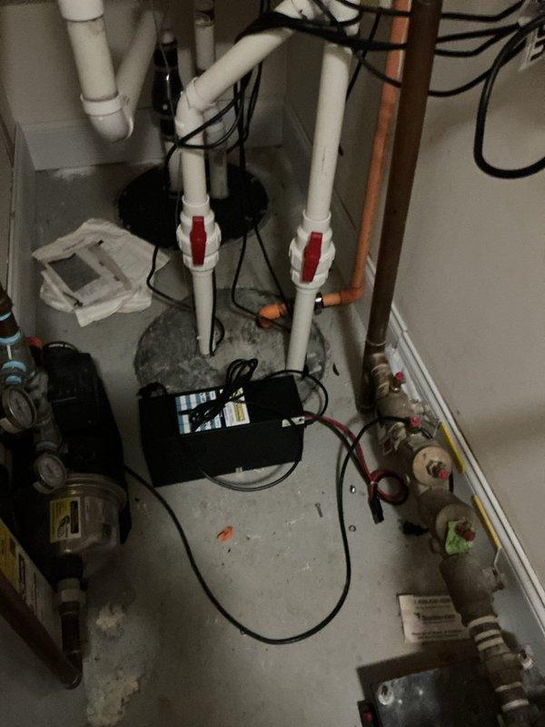 Responded to warranty inquiry regarding previously replaced battery backup system that triggered carbon monoxide detectors. Upon inspection, located battery backup unit in mechanical room connected to plumbing system with PVC piping and shut-off valves. Evaluated backup power supply unit and associated electrical connections for proper operation. Inspected external battery box on deck area, confirming battery installation and cable connections to positive and negative terminals. Documented equipment condition and configuration with photographs for warranty assessment purposes.