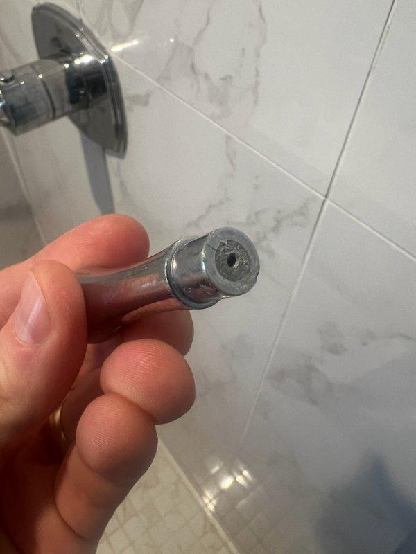 Responded to shower valve malfunction and completed fixture repair. Removed and inspected flow restrictor showing significant mineral buildup and deposits. Serviced Grohe shower control valve assembly and restored proper water flow operation.