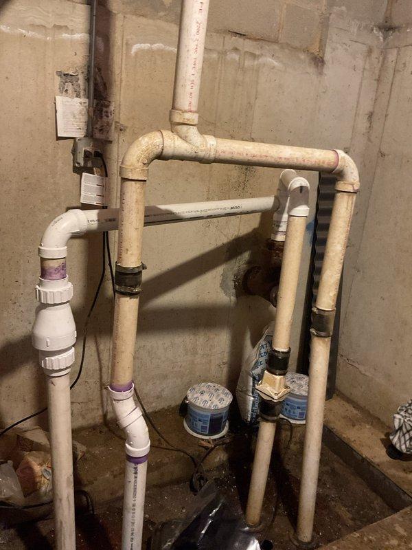 Responded to service call regarding malfunctioning ejector pump system experiencing frequent backups and foul odors. Upon inspection, documented existing PVC plumbing configuration in basement utility area, including multiple pipe connections with rubber couplings and floor drain assembly. Assessed system for proper operation, drainage flow, and potential causes of backup issues including pump performance, discharge line integrity, and ventilation adequacy.