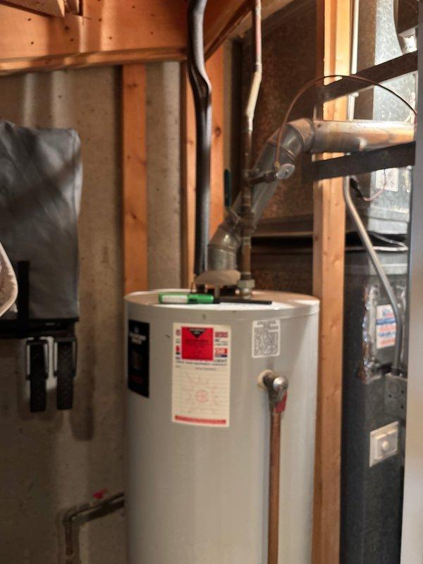 Responded to no hot water complaint following recent plumbing work for washer/dryer installation. Upon arrival, confirmed no hot water at any fixtures throughout the home. Investigated gas supply to tanked water heater and discovered gas shut-off valve remained in closed position from previous service visit. Reopened gas supply valve, verified proper gas flow to unit, and relit pilot light on water heater. Inspected burner assembly for proper ignition and flame pattern. Confirmed thermostat settings were appropriate and tested temperature-pressure relief valve for proper operation. Monitored unit through complete heating cycle to ensure consistent burner operation. Verified hot water delivery restored to all fixtures. Educated homeowner on location of gas shut-off valve and proper pilot light operation for future reference.