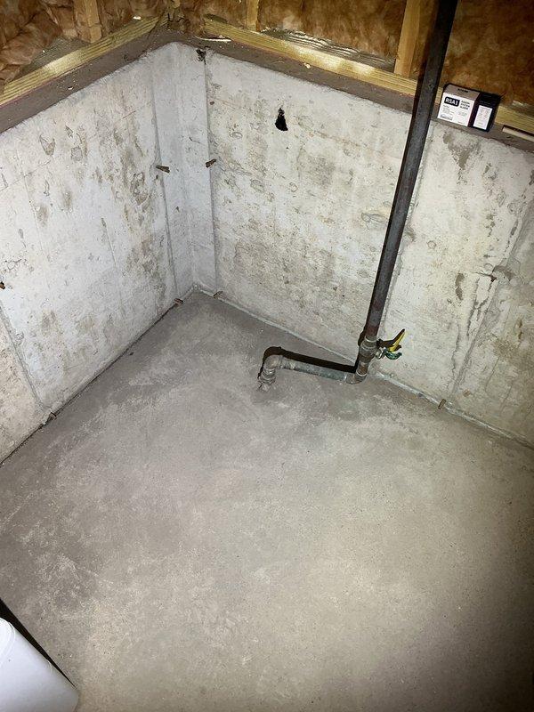 Responded to high water usage complaint with continuously running water meter. Confirmed water meter activity ceased when shutoff valve to coach house was closed, isolating leak to underground supply line between main house and coach house. Inspected basement plumbing connections and shutoff valve assembly serving coach house line. Documented condition of pipe penetration through foundation wall and valve configuration. Advised customer of suspected underground leak in buried water line to coach house, as no audible leaks detected in coach house interior and meter test confirmed issue isolated to that supply line.