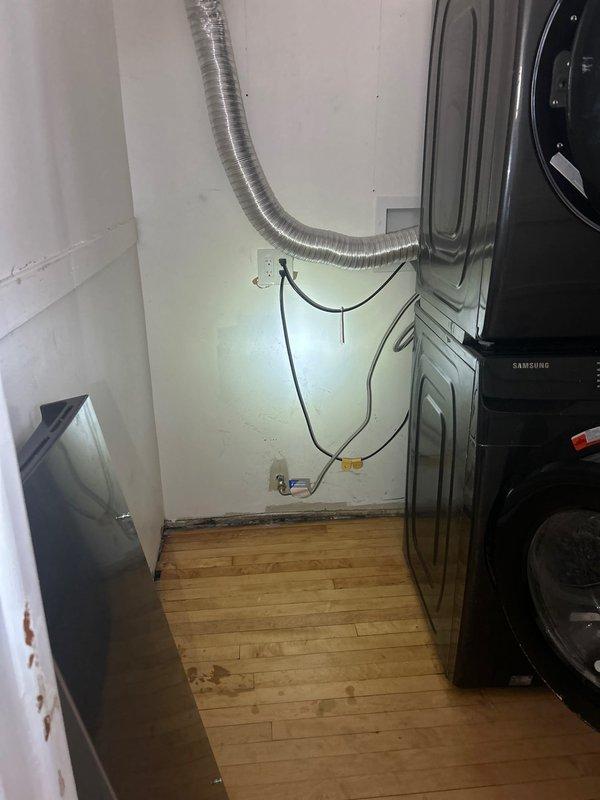 Completed assessment of second-floor gas piping system to provide re-pipe estimate. Inspected existing natural gas meter installation mounted on brick wall, noting significant corrosion and weathering on aged metal piping network, valves, and fittings. Evaluated utility room area containing laundry appliances to determine routing requirements and access points for new gas line installation. Documented current pipe configuration, valve locations, and connection points. Photographed existing conditions including corroded gas distribution piping and available workspace to develop accurate scope of work for complete second-floor gas line replacement project.