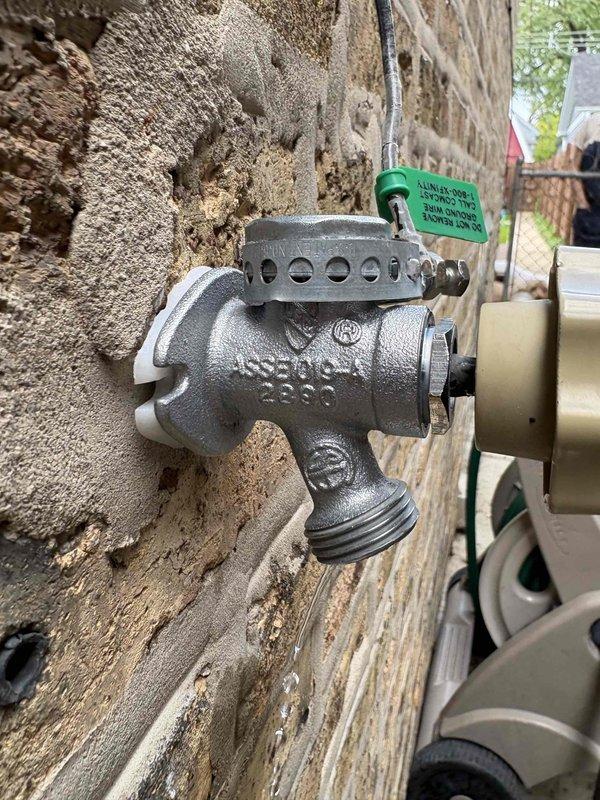 # Outdoor Spigot Repair

Responded to service call for exterior spigot leaking when in closed position. Upon inspection, identified Woodford model 23CP vacuum breaker assembly with compromised internal seals causing continuous water seepage. Disassembled the anti-siphon valve and vacuum breaker components mounted on exterior wall. Replaced worn rubber washers and internal valve seat that had deteriorated due to weather exposure and mineral buildup. Tested valve operation through multiple open/close cycles to verify proper shutoff and confirmed no residual leaking. Inspected backflow prevention device for proper function and ensured threaded hose connection coupling remained secure. Verified complete water shutoff when valve handle returned to closed position.