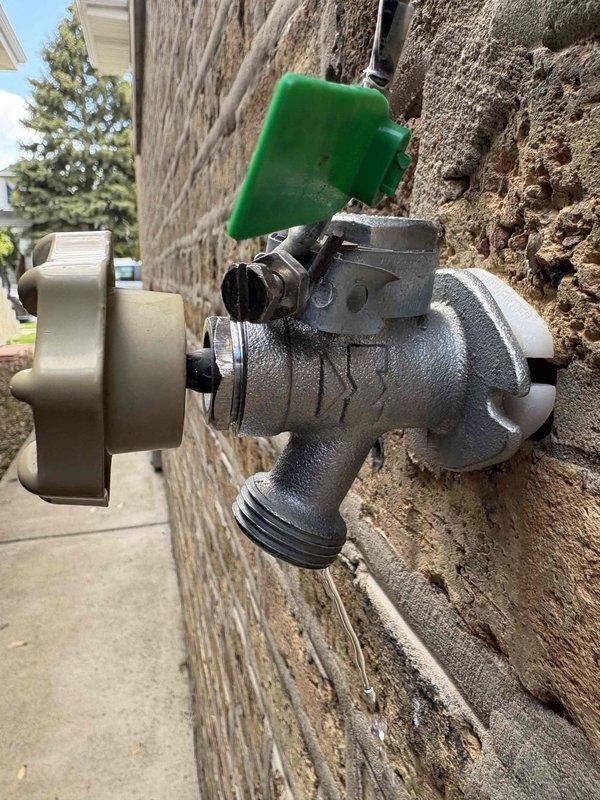 # Outdoor Spigot Repair

Responded to service call for exterior spigot leaking when in closed position. Upon inspection, identified Woodford model 23CP vacuum breaker assembly with compromised internal seals causing continuous water seepage. Disassembled the anti-siphon valve and vacuum breaker components mounted on exterior wall. Replaced worn rubber washers and internal valve seat that had deteriorated due to weather exposure and mineral buildup. Tested valve operation through multiple open/close cycles to verify proper shutoff and confirmed no residual leaking. Inspected backflow prevention device for proper function and ensured threaded hose connection coupling remained secure. Verified complete water shutoff when valve handle returned to closed position.