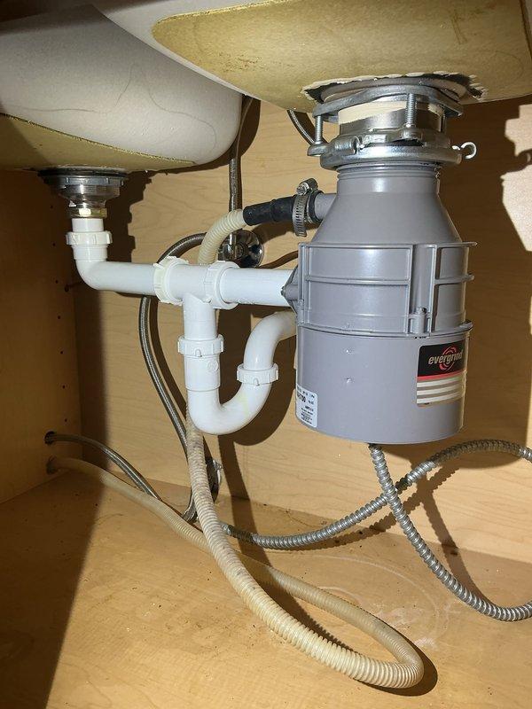 Performed comprehensive plumbing assessment and identified multiple system deficiencies requiring attention. Inspected garbage disposal unit beneath kitchen sink and determined motor failure necessitating full replacement. Evaluated flood control system and confirmed motor malfunction requiring new component installation. Completed water heater maintenance service including full tank flush to remove sediment buildup and restore optimal heating efficiency.
