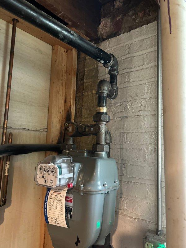 Responded to gas leak in single family home utility room. Isolated and removed all compromised gas piping serving furnace and water heater. Installed new gas distribution system using 1-1/4", 1", 3/4", and 1/2" black iron pipe with appropriate gas mega press couplings and threaded fittings, properly sized to accommodate BTU requirements of both appliances. Pressure tested complete system at 5 PSI for 15 minutes per code requirements with successful hold, confirming leak-free installation and safe operation.