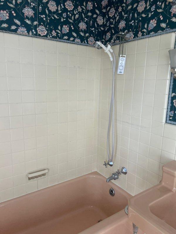 Conducted follow-up plumbing inspection of bathroom fixtures and piping systems. Documented existing conditions of toilet installation, bathtub and shower assembly, including water supply lines, shut-off valves, and chrome fixtures. Photographed plumbing connections and overall system configuration for estimate preparation.