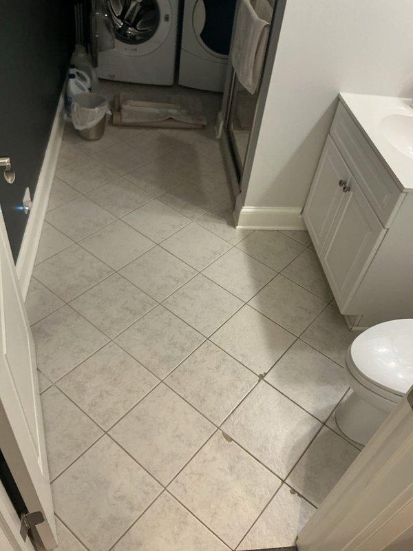 Responded to clogged drain service call at residential property. Technician and helper arrived for morning appointment with floor protection as requested. Successfully cleared drainage obstruction in bathroom and laundry area, restoring proper water flow. Documented work site conditions with photographic evidence showing bathroom fixtures, tile flooring, and laundry appliances in affected areas.