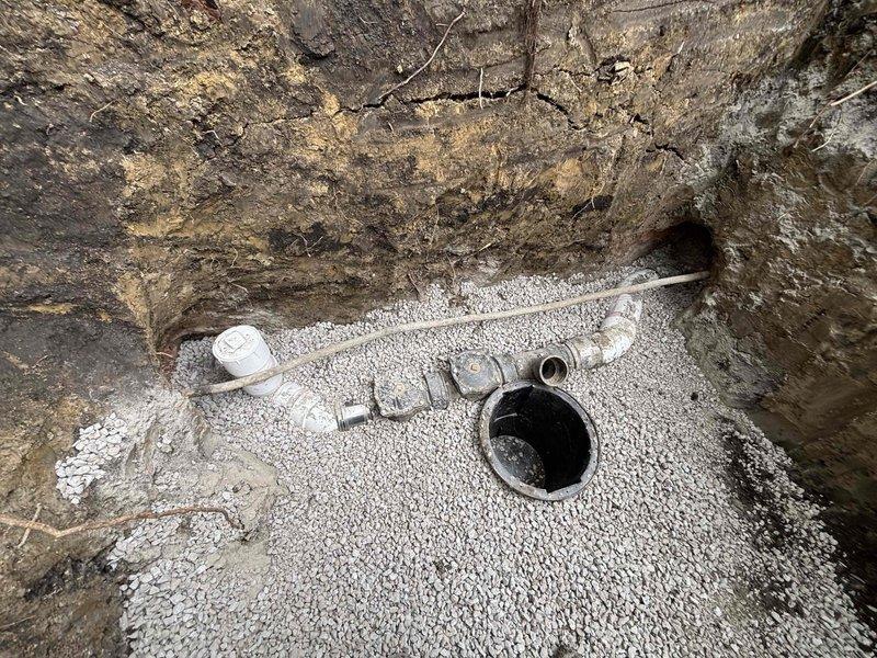 Completed installation of flood control drainage system with excavated trench and subsurface drainage components. Installed PVC piping network with junction fittings, cleanout access point, and connection to main drainage line, all properly bedded in white gravel base for optimal water permeation and system stability. Financing was approved and appointment scheduled for final inspection.