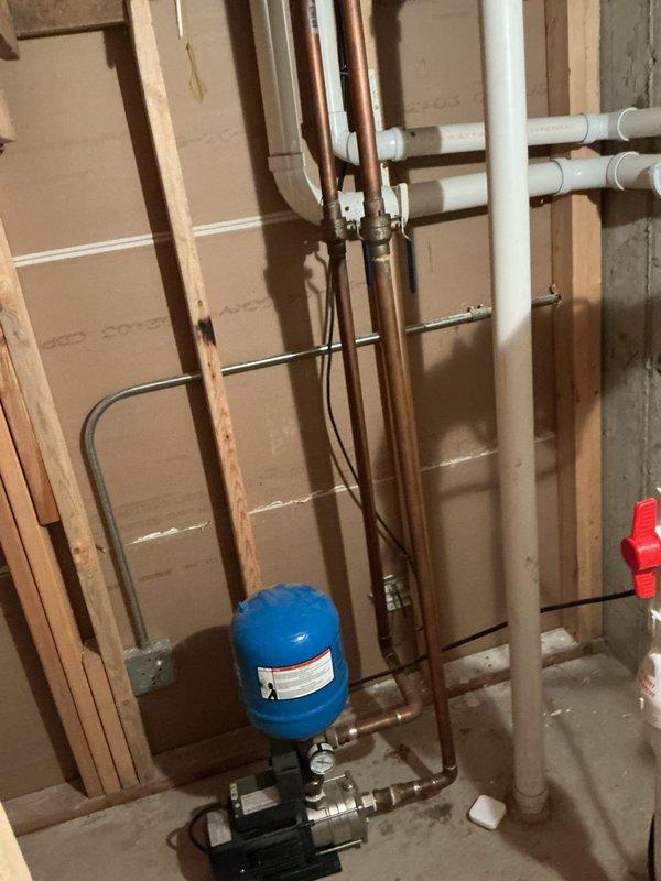 Completed comprehensive plumbing maintenance inspection including tankless water heater flush and descale service as requested. Inspected well pressure system, pressure tank, and associated copper and PVC supply lines in mechanical room, confirming proper operation and connections. Verified sump pump control system functionality, including ion Genesis digital controller with dual pump capability, water level sensors, and alarm contacts, with all components operating within normal parameters.