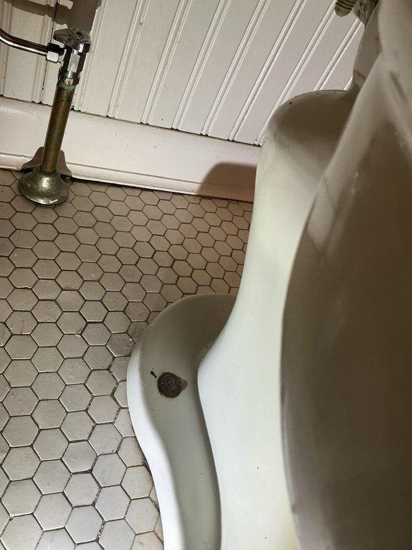Responded to service call for downstairs toilet experiencing slow drainage and incomplete flushing. Upon arrival, confirmed that fixture had been previously plunged and snaked with no visible obstruction found, yet continued to exhibit sluggish flow, particularly when toilet paper was present. Conducted thorough diagnostic inspection of the toilet bowl, trapway, and visible drainage connections. Assessed the flush mechanism, water supply line with braided connector, and shut-off valve for proper operation. Documented existing conditions including hexagonal tile flooring and fixture placement against tiled wall. Based on diagnostic findings and symptoms of persistent slow drainage without identifiable blockage in accessible areas, determined that issue likely stems from partial obstruction deeper in the drain line beyond the toilet trap or potential venting problems affecting drainage performance. Provided assessment and recommended options for resolution.