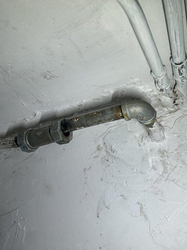 # Plumbing Service - Clogged Drain/Sink

Responded to clogged drain service call in basement utility area. Upon inspection, accessed main drain line using pipe wrench to remove cleanout plug near overhead plumbing junction. Successfully cleared obstruction from drain system and verified proper water flow. Reinstalled cleanout plug and confirmed all connections were secure with no leaks present.