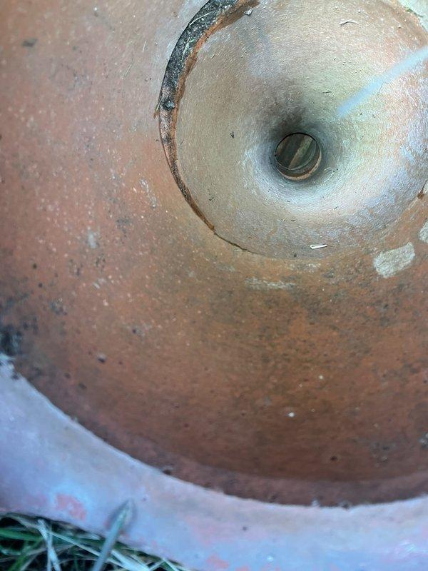 Completed cleanout repair on main sewer line access point, addressing damaged brick surround and performing rodding service to clear downspout drainage system. Repaired ground-level cleanout assembly with oxidized brass cap and restored functionality to the cylindrical pipe access point. Documentation photos captured pre-existing conditions including deteriorated brickwork around the cleanout and interior pipe condition showing rust discoloration and mineral deposits.