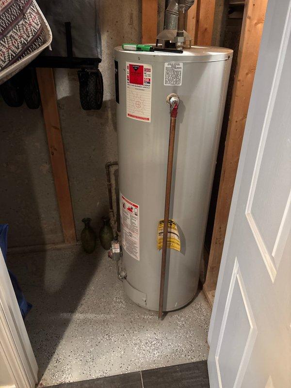 Successfully replaced existing 50-gallon tanked water heater with new unit supplied by Goode Plumbing in basement utility room. Removed old water heater and installed replacement unit, connecting all copper supply lines, pressure relief valve discharge piping, and gas connections per manufacturer specifications and local code requirements. Verified proper operation of all plumbing connections, tested for leaks, and confirmed water heater is functioning correctly with appropriate temperature settings.