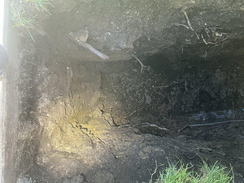 Conducted comprehensive assessment of residential drain and sewer system revealing extensive corrosion throughout basement plumbing infrastructure. Primary concerns identified include severely deteriorated valve assemblies with advanced rust and blue-green patina indicating copper corrosion, heavy mineral deposits and calcification on multiple pipe sections, and mixed-material connections between galvanized steel and copper components showing signs of galvanic corrosion. Exterior evaluation documented ground conditions near foundation with exposed soil transitions and concrete borders, suggesting potential drainage or sewer line access points requiring further investigation for proper repair planning and material replacement specifications.
