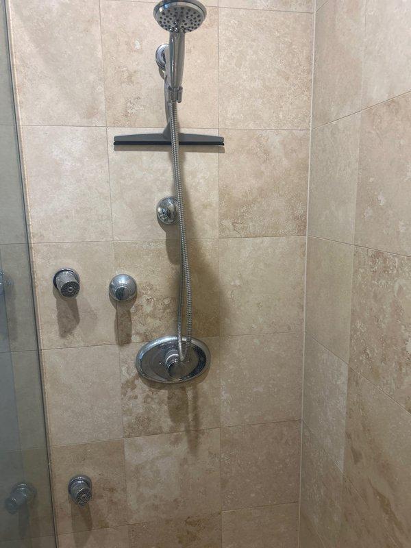 Completed replacement of six water shut-off valves across two bathrooms in a historic residential condo unit. Replaced shower cartridge in tiled shower enclosure with chrome fixtures and handheld spray system. All cutoff valves were successfully installed and tested for proper operation, ensuring reliable water control at fixture supply lines.