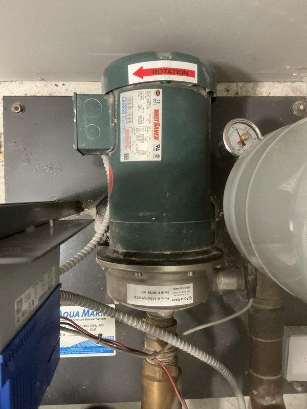 Replaced and installed new Aqua Mark water pump system in basement utility area. The installation included mounting the pump assembly on a secure base plate, connecting to existing copper piping infrastructure, installing pressure gauge for system monitoring, and completing all electrical connections with proper conduit protection. System was tested and verified operational with correct rotation direction confirmed.