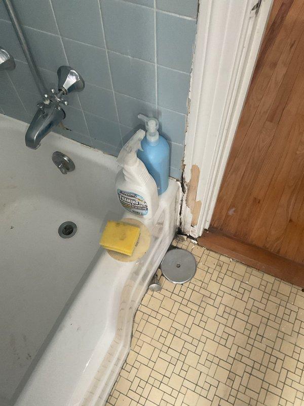 Completed installation of chrome bathtub fixtures including faucet and control knobs mounted to tiled wall surface. All fixtures were installed to manufacturer specifications with proper sealing and water supply connections verified for leak-free operation.
