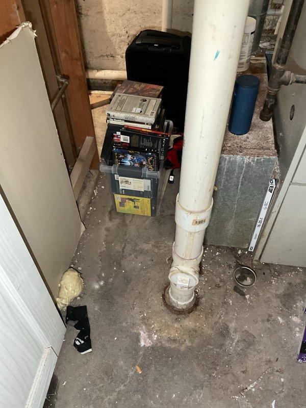 Responded to complaints of sewer odor and water backup affecting basement toilet and bathtub, with sump pump running continuously following recent heavy rainfall. Performed rodding service on clogged floor drain located near back door exterior, removing accumulated debris including leaves and organic matter from drain grate and line. Inspected basement plumbing system including vertical PVC drain lines and sump pump operation to identify source of backup and verify proper drainage function was restored.